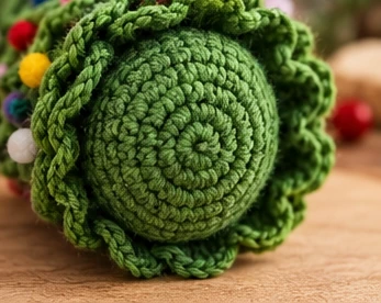 CrochetSmith illustration of the ornament's underside, showing the small crocheted base disc covering the cone's bottom edge.